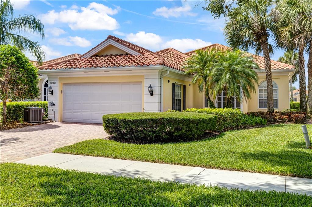 3888 Valentia Way Naples, FL 34119 - Photo 1 of 48 a front view of a house with a garden