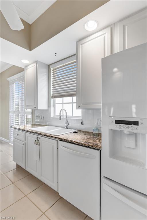 3888 Valentia Way Naples, FL 34119 - Photo 11 of 48 a bathroom with a granite countertop sink and a mirror