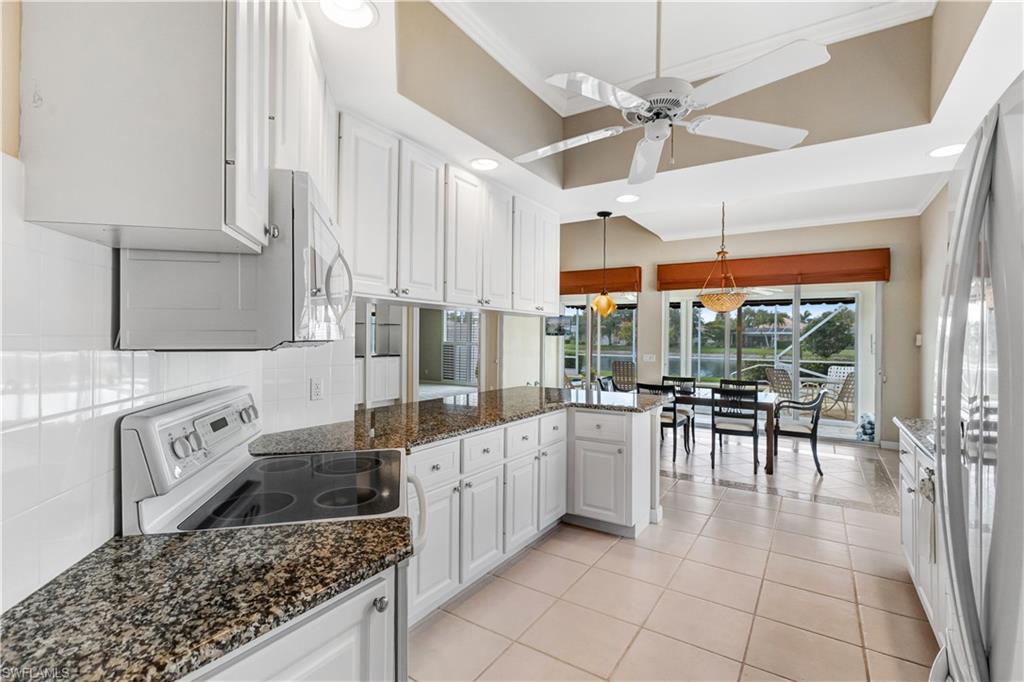 3888 Valentia Way Naples, FL 34119 - Photo 14 of 48 a kitchen with a sink a counter top space and stainless steel appliances