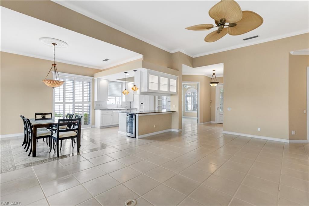 3888 Valentia Way Naples, FL 34119 - Photo 21 of 48 a open kitchen with cabinets and stainless steel appliances