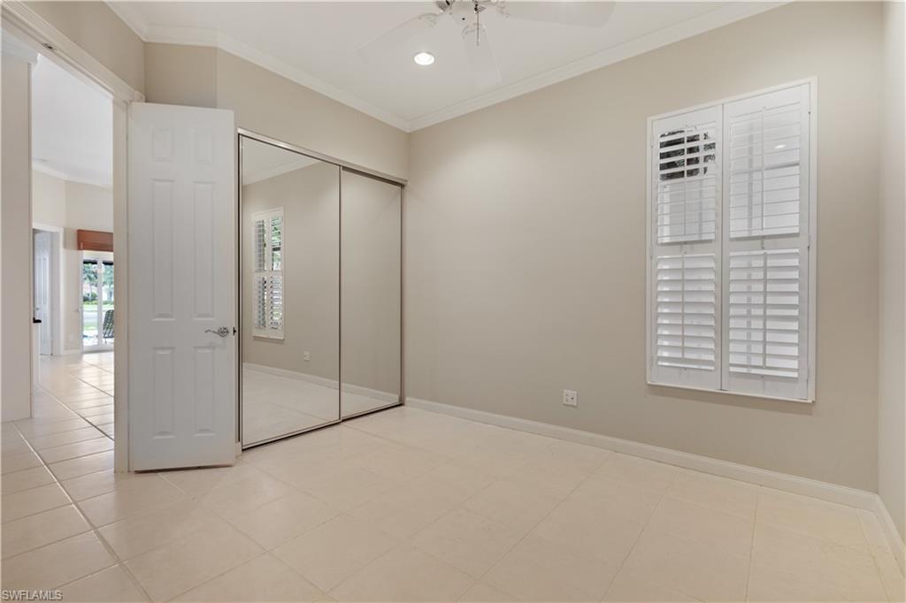 3888 Valentia Way Naples, FL 34119 - Photo 22 of 48 an empty room with windows and closet