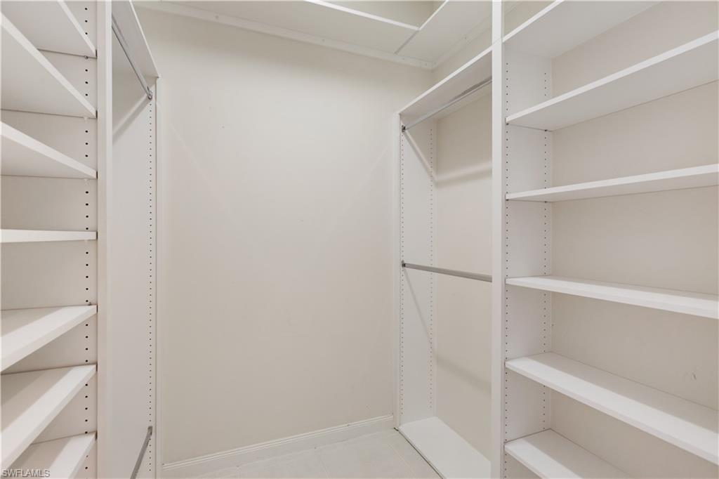 3888 Valentia Way Naples, FL 34119 - Photo 27 of 48 a view of walk in closet with empty racks