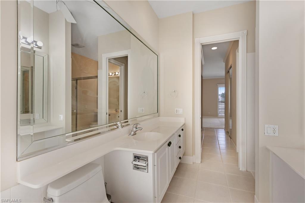 3888 Valentia Way Naples, FL 34119 - Photo 28 of 48 a bathroom with a double vanity sink mirror and bathtub