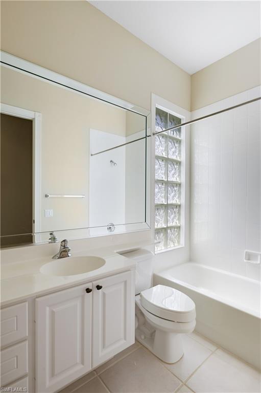 3888 Valentia Way Naples, FL 34119 - Photo 29 of 48 a bathroom with a granite countertop sink a toilet and shower