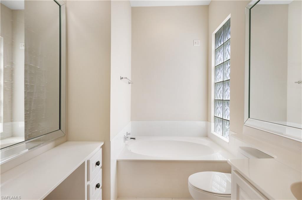 3888 Valentia Way Naples, FL 34119 - Photo 30 of 48 a bathroom with a bathtub sink and toilet
