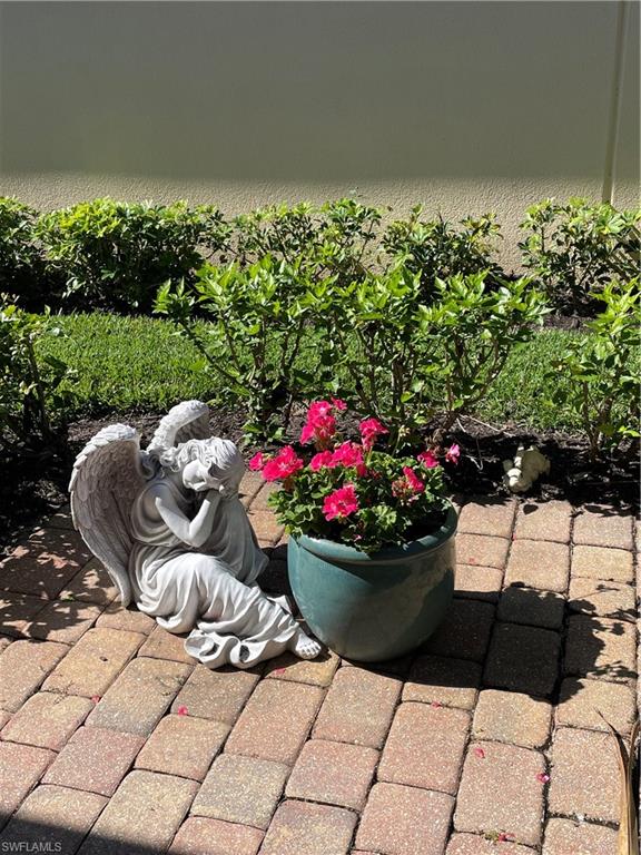 3888 Valentia Way Naples, FL 34119 - Photo 3 of 48 a table and chairs in a garden