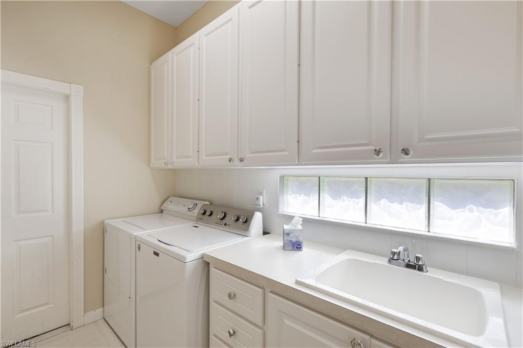 3888 Valentia Way Naples, FL 34119 - Photo 32 of 48 a bathroom with a sink and cabinets