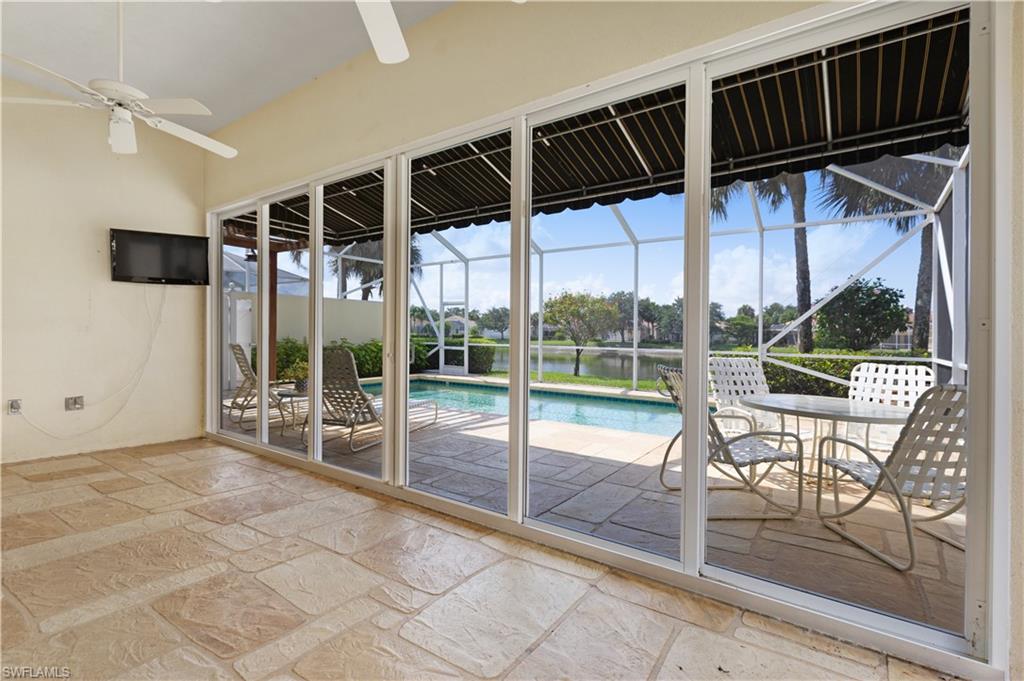 3888 Valentia Way Naples, FL 34119 - Photo 36 of 48 a view of swimming pool with a patio and a yard