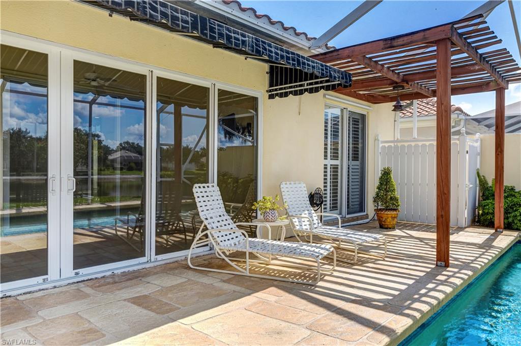 3888 Valentia Way Naples, FL 34119 - Photo 37 of 48 a view of a porch with a table and chairs