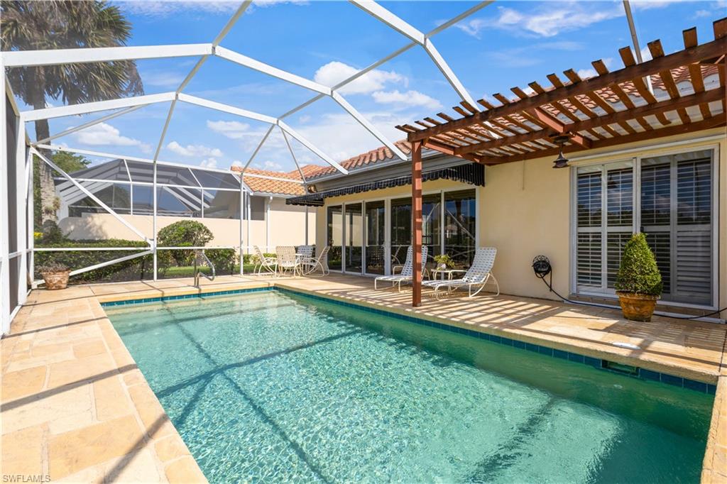 3888 Valentia Way Naples, FL 34119 - Photo 38 of 48 a view of a backyard with swimming pool in front of it