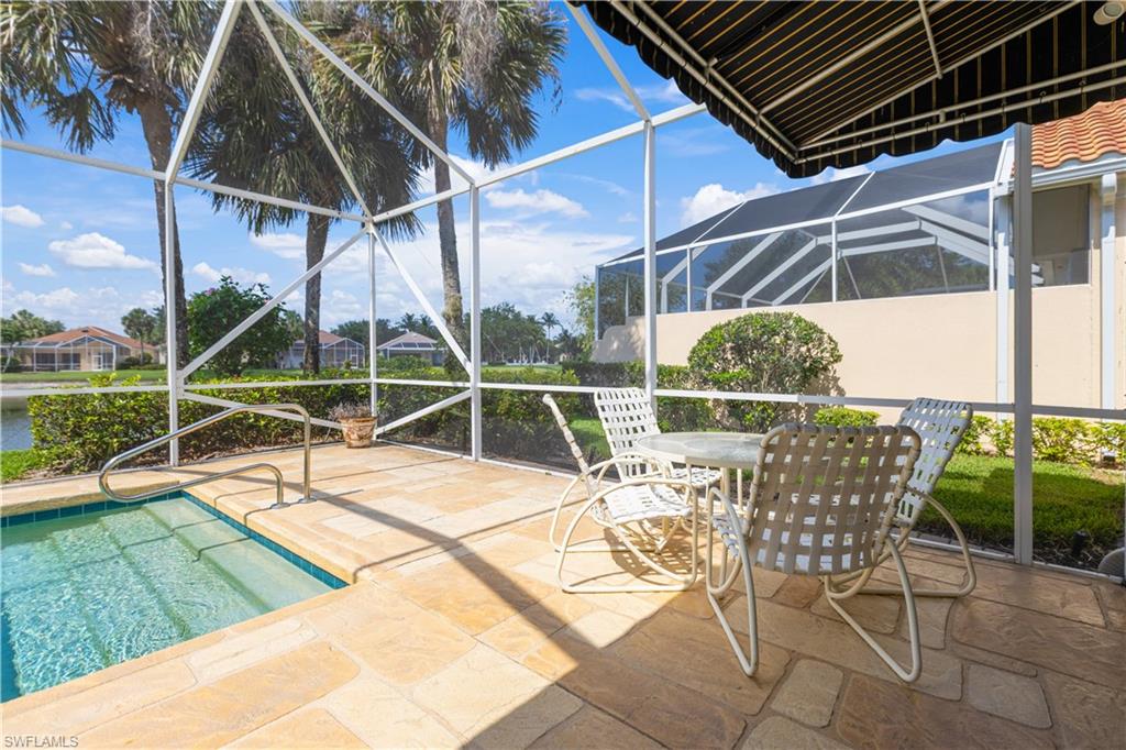 3888 Valentia Way Naples, FL 34119 - Photo 5 of 48 a view of a swimming pool with a patio