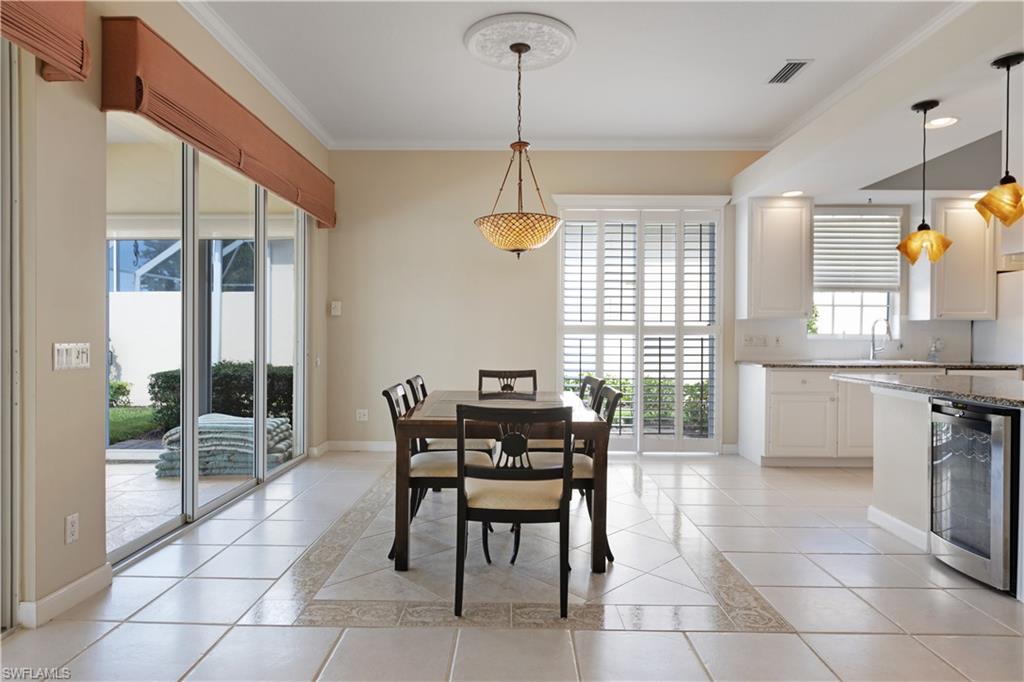 3888 Valentia Way Naples, FL 34119 - Photo 9 of 48 a dining room filled with furniture and window