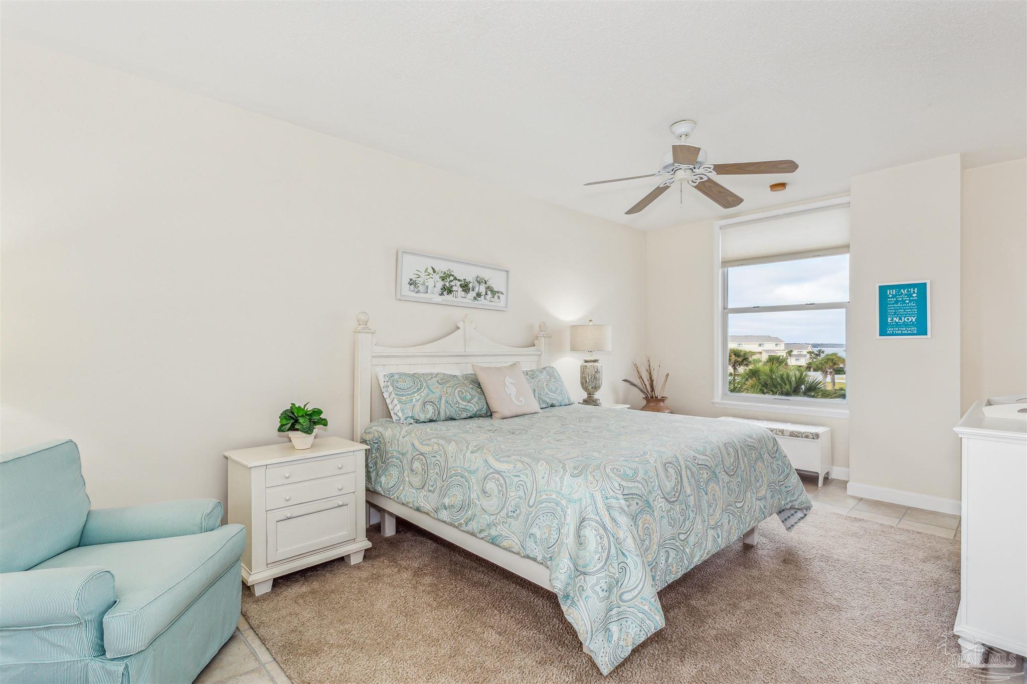 800 Fort Pickens Road, Unit 204 Pensacola Beach, FL 32561 - Photo 29 of 45 a bedroom with a bed couch and window