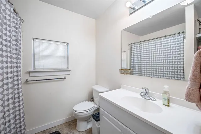 a bathroom with a sink a toilet and mirror