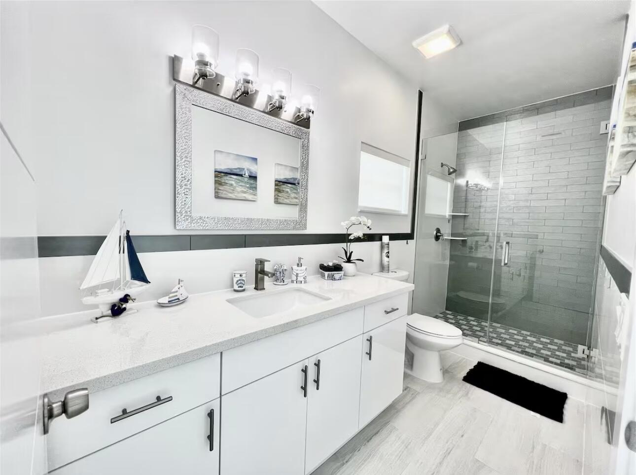 1021 82nd Street Marathon, FL 33050 - Photo 13 of 33 a bathroom with a double vanity sink toilet and shower