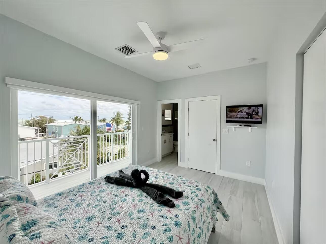 1021 82nd Street Marathon, FL 33050 - Photo 19 of 33 a bedroom with a bed and glass wall painting