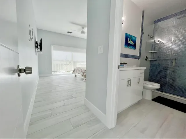 an aerial view of residential houses with outdoor space and lake view