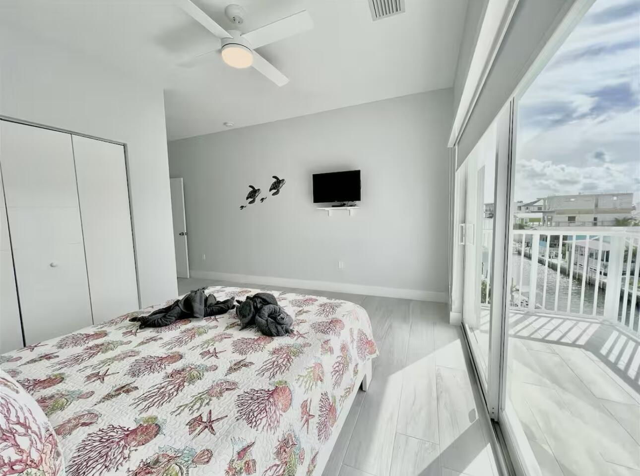 1021 82nd Street Marathon, FL 33050 - Photo 22 of 33 a bedroom with a bed and a chandelier