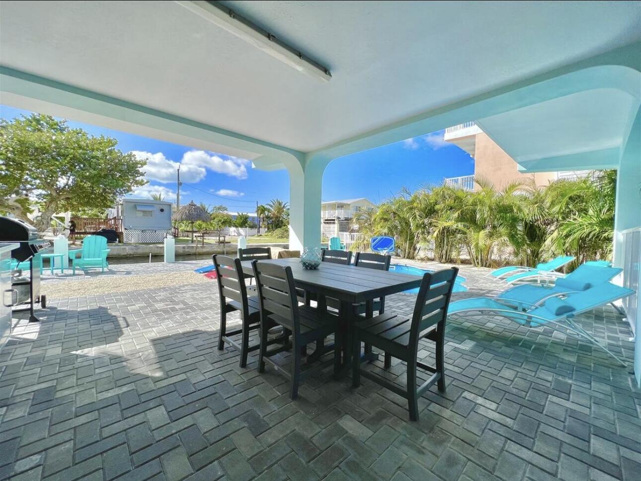 1021 82nd Street Marathon, FL 33050 - Photo 24 of 33 a view of a patio with a table and chairs