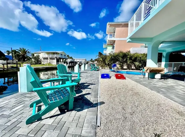 a view of a house with swimming pool and sitting area
