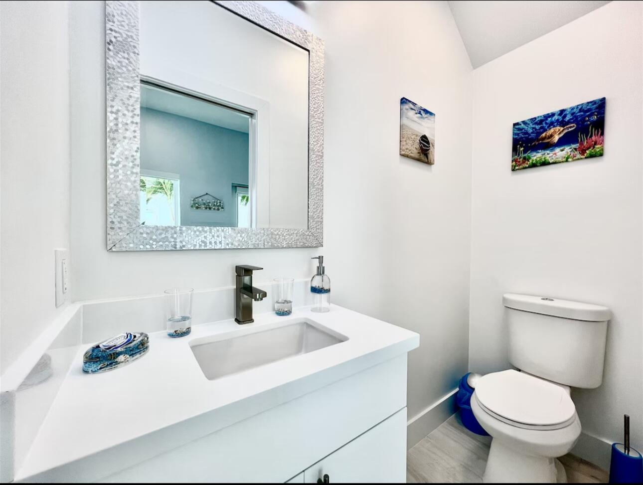 1021 82nd Street Marathon, FL 33050 - Photo 5 of 33 a bathroom with a toilet sink and mirror