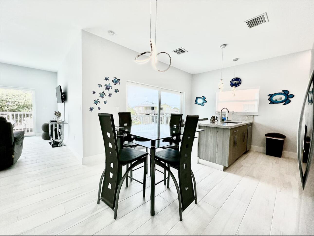 1021 82nd Street Marathon, FL 33050 - Photo 6 of 33 a view of a dining room with furniture and chandelier