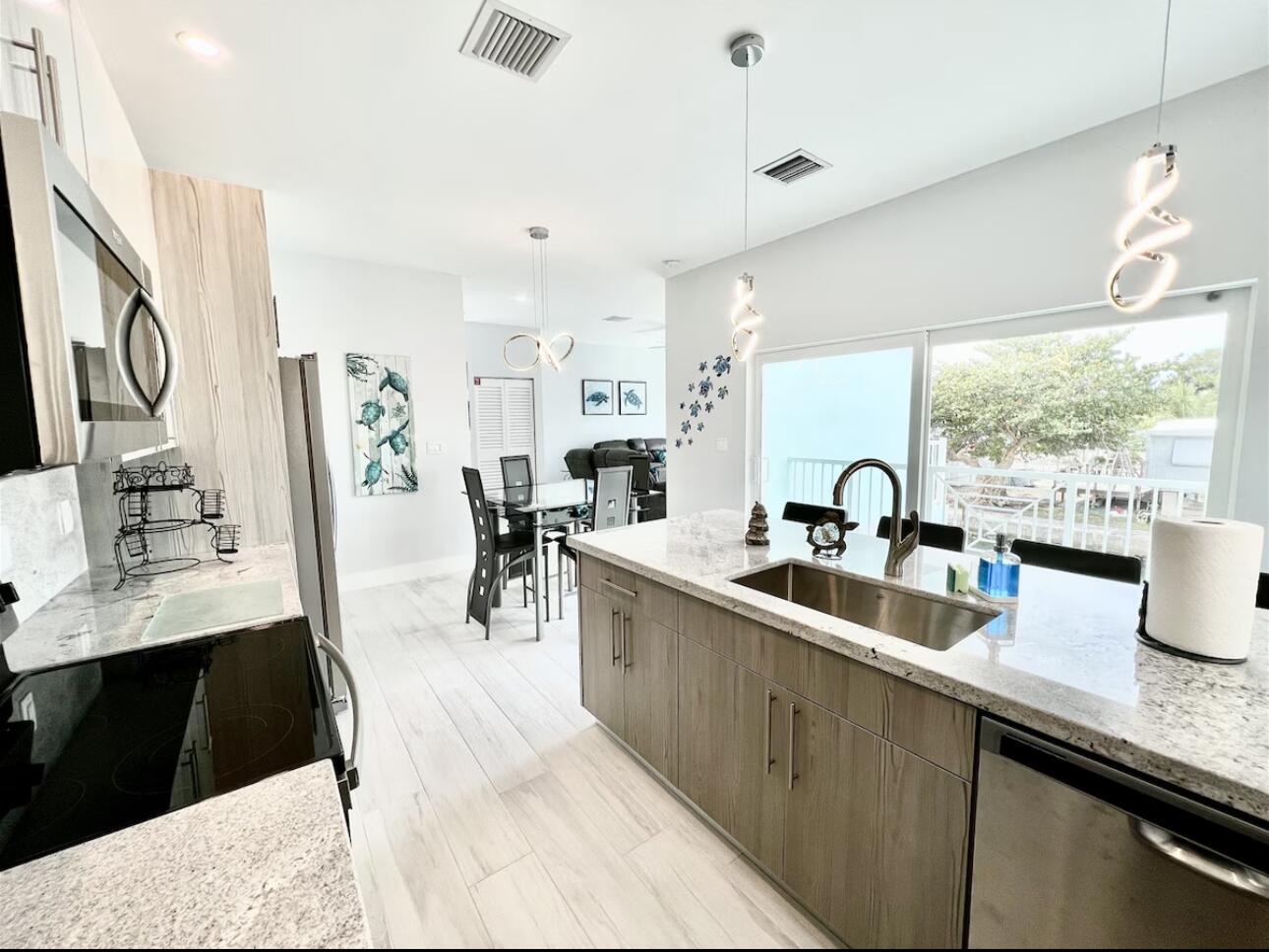 1021 82nd Street Marathon, FL 33050 - Photo 7 of 33 a kitchen with sink cabinets and outdoor view