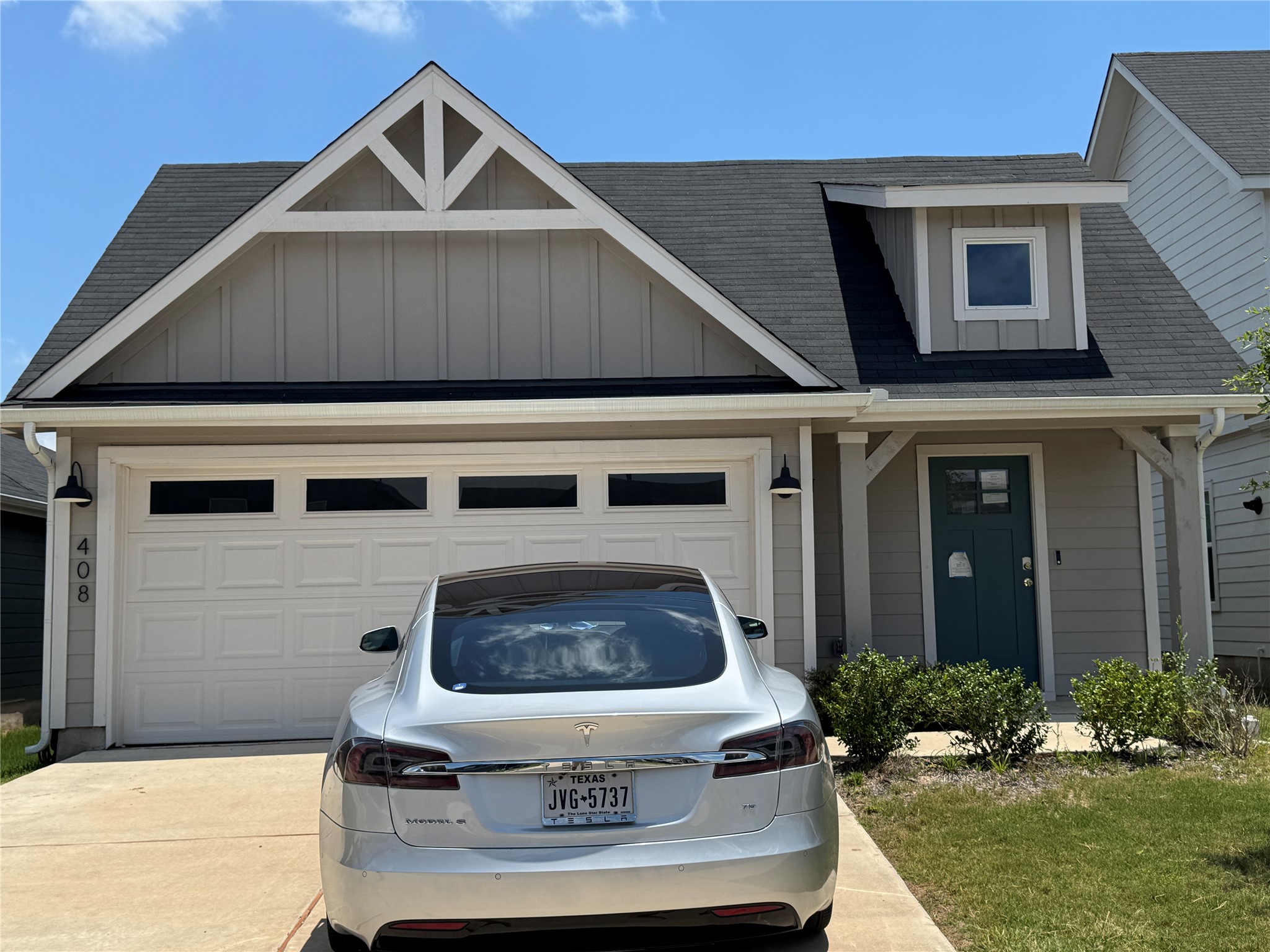A well-maintained facade with a prominent garage and inviting entry.