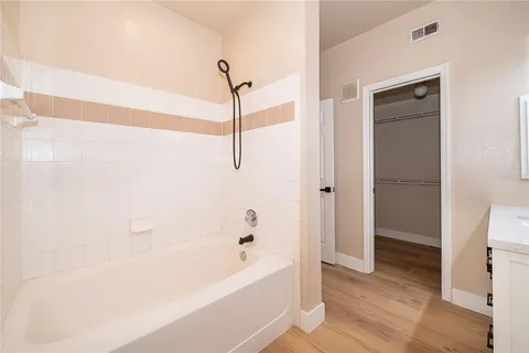 a bathroom with a bathtub and a shower