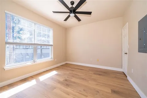 wooden floor in an empty room with a window