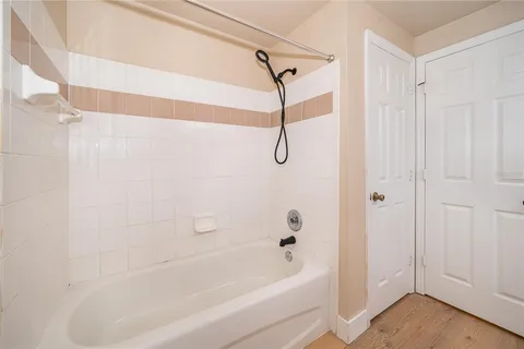 a bathroom with a bathtub and shower