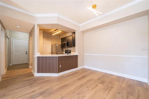 a view of a room with wooden floor and windows