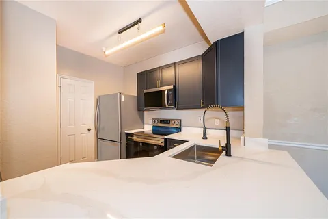 a kitchen with a refrigerator sink and stainless steel appliances
