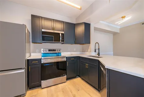 a kitchen with a sink and stainless steel appliances