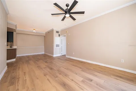 a view of a livingroom with a hardwood floor and a ceiling fan