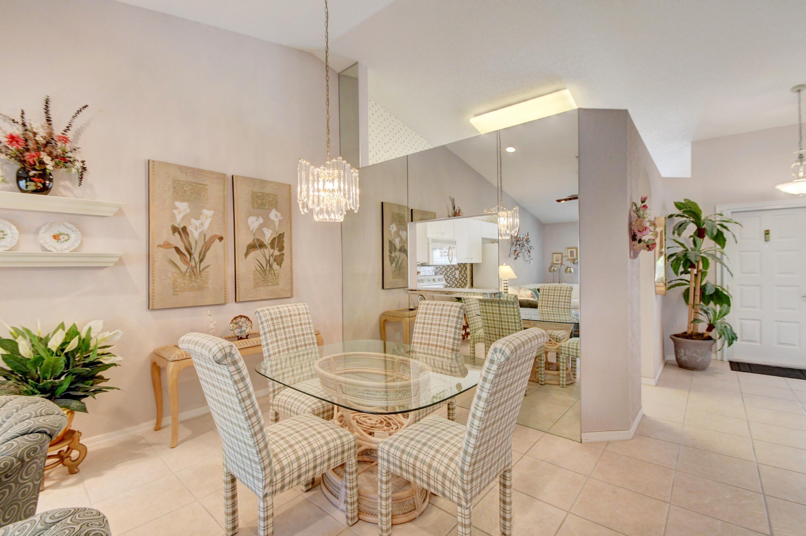 6121 Heliconia Road Delray Beach, FL 33484 - Photo 12 of 49 a dining room with furniture and wooden floor