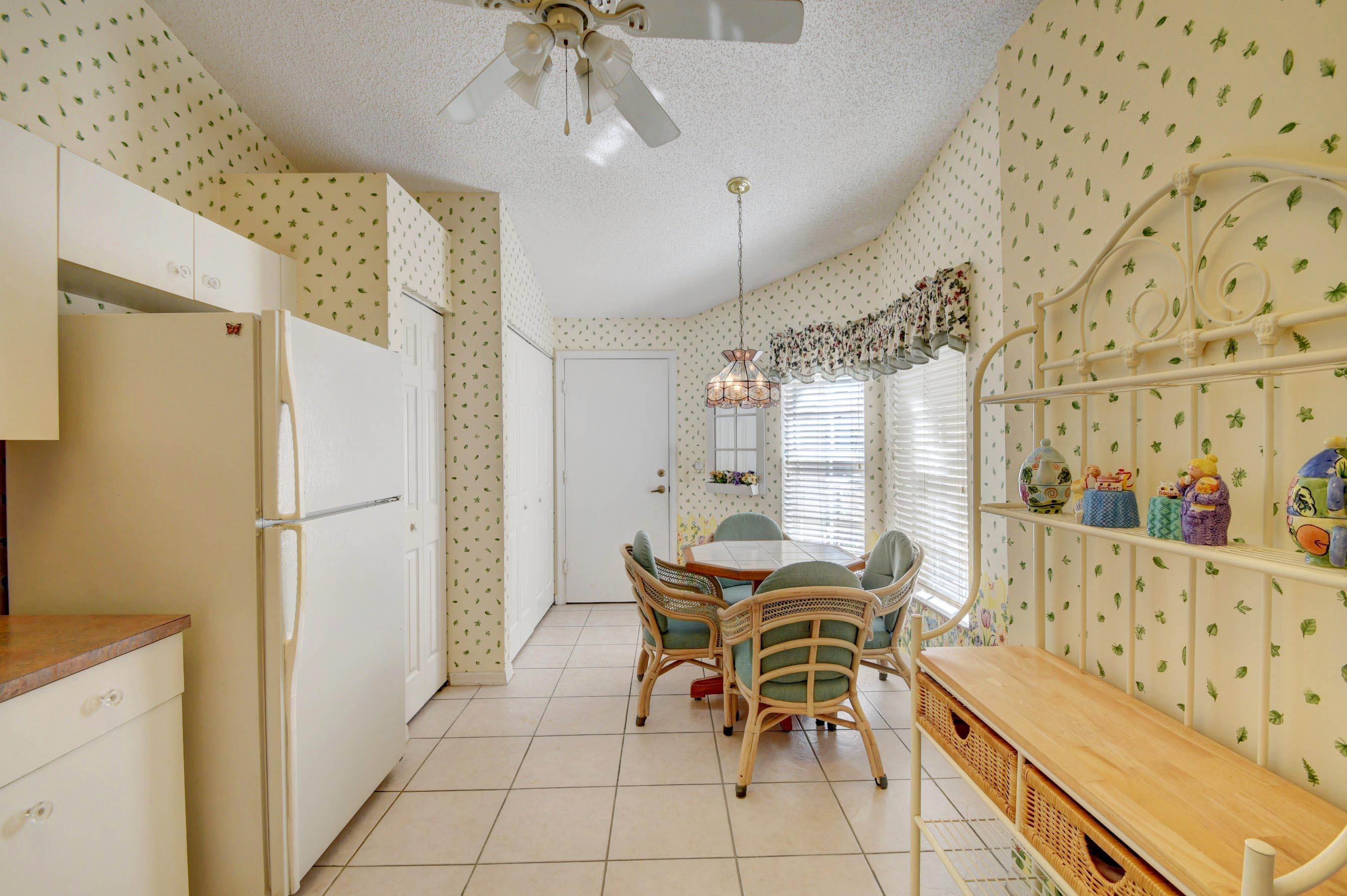 6121 Heliconia Road Delray Beach, FL 33484 - Photo 14 of 49 a dining room with furniture and window