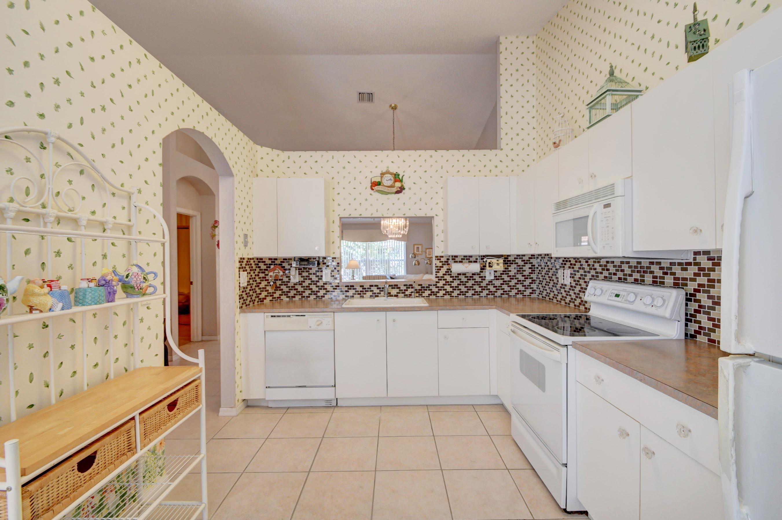 6121 Heliconia Road Delray Beach, FL 33484 - Photo 16 of 49 a kitchen with a sink and cabinets