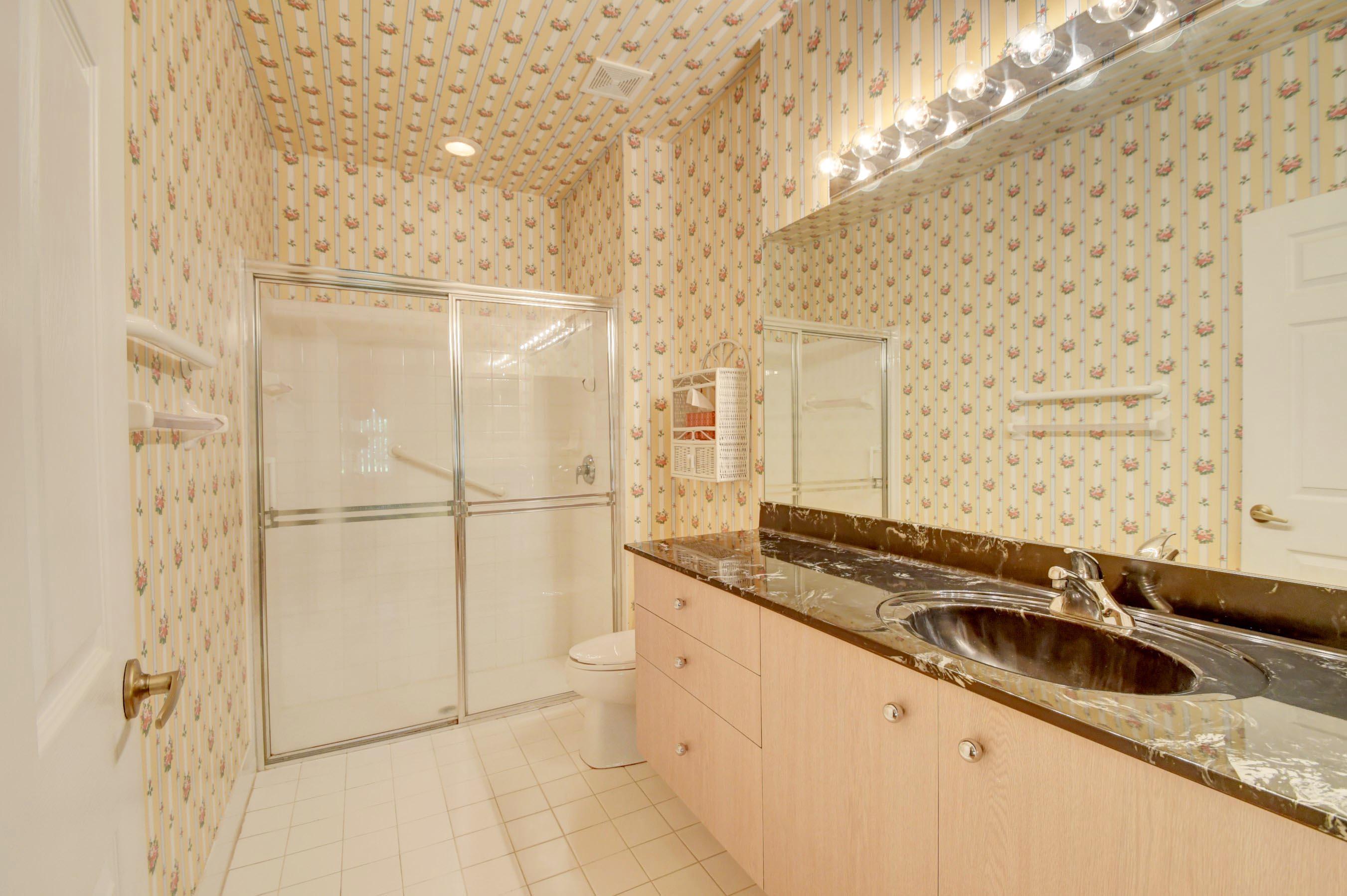 6121 Heliconia Road Delray Beach, FL 33484 - Photo 20 of 49 a bathroom with a sink and a mirror