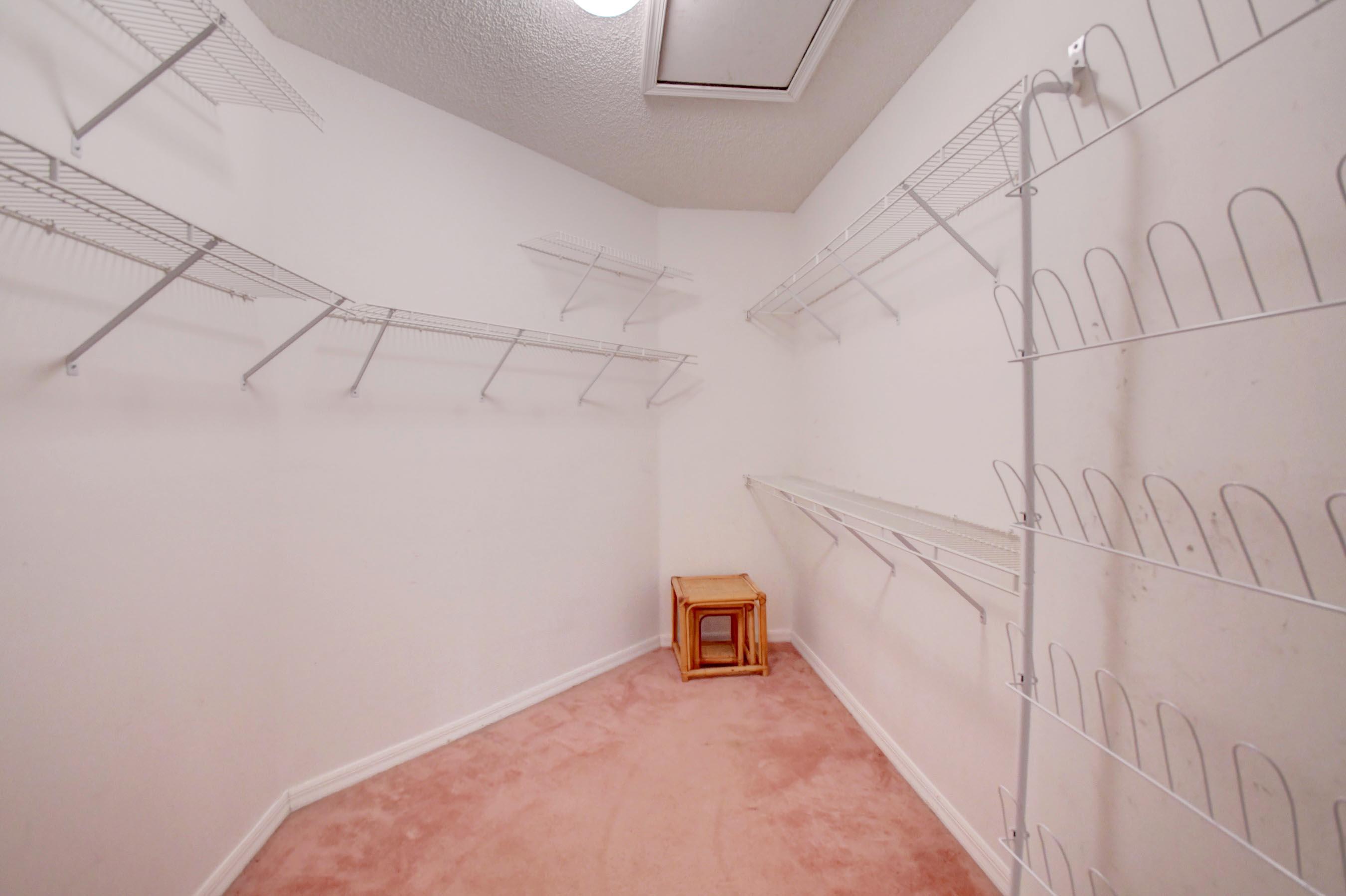 6121 Heliconia Road Delray Beach, FL 33484 - Photo 21 of 49 a view of a room with racks on the wall