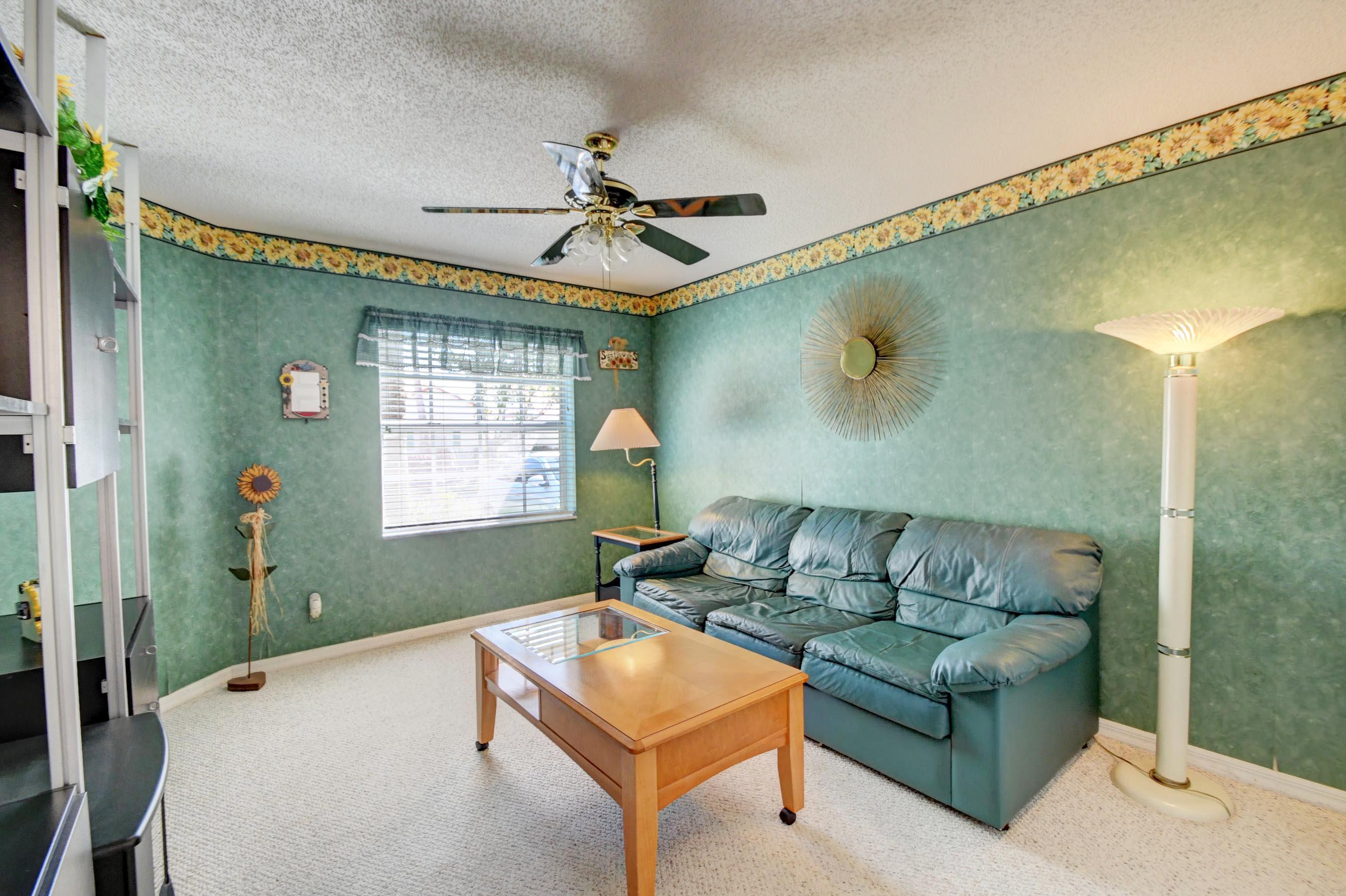 6121 Heliconia Road Delray Beach, FL 33484 - Photo 22 of 49 a living room with furniture and a window