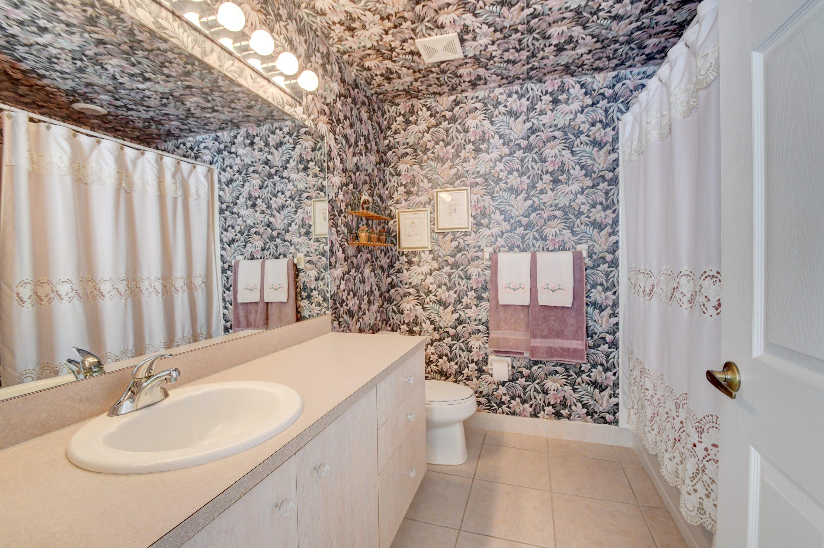 6121 Heliconia Road Delray Beach, FL 33484 - Photo 24 of 49 a bathroom with a sink toilet and shower