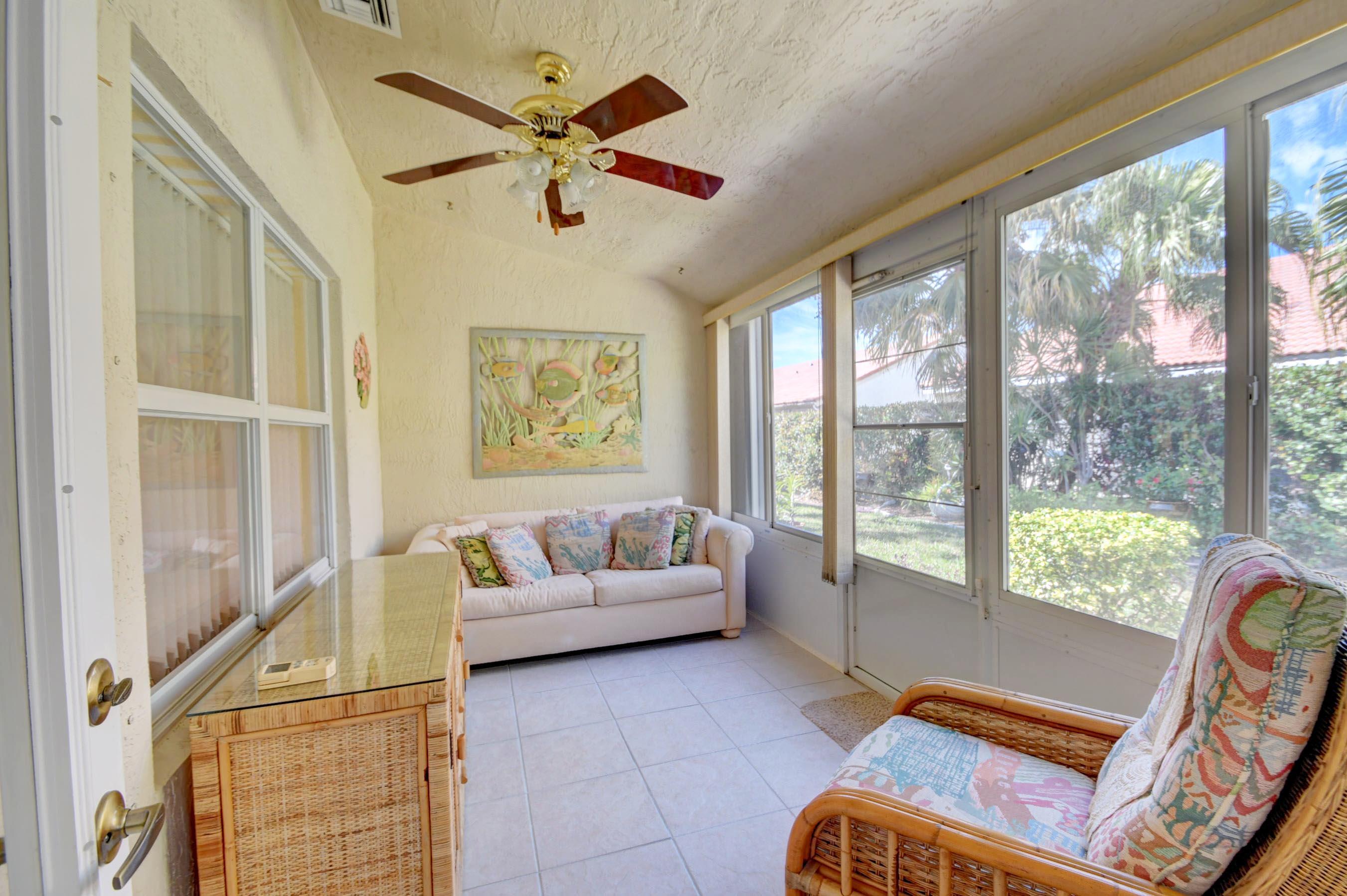 6121 Heliconia Road Delray Beach, FL 33484 - Photo 25 of 49 a living room with furniture and a large window