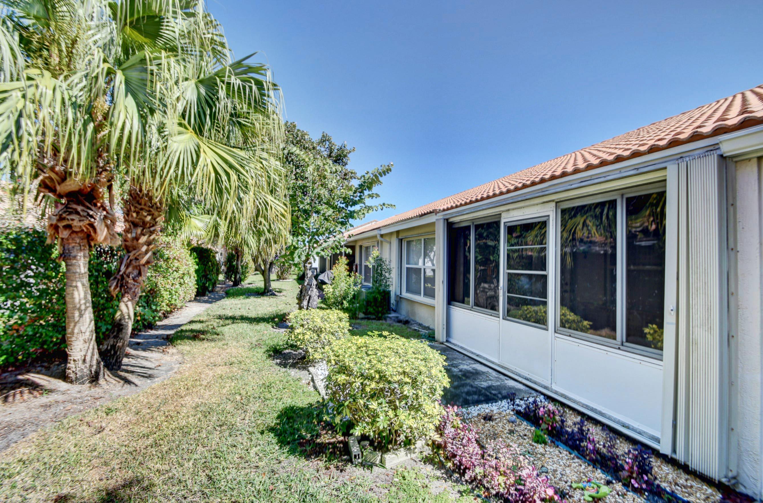 6121 Heliconia Road Delray Beach, FL 33484 - Photo 26 of 49 front view of a house with a yard