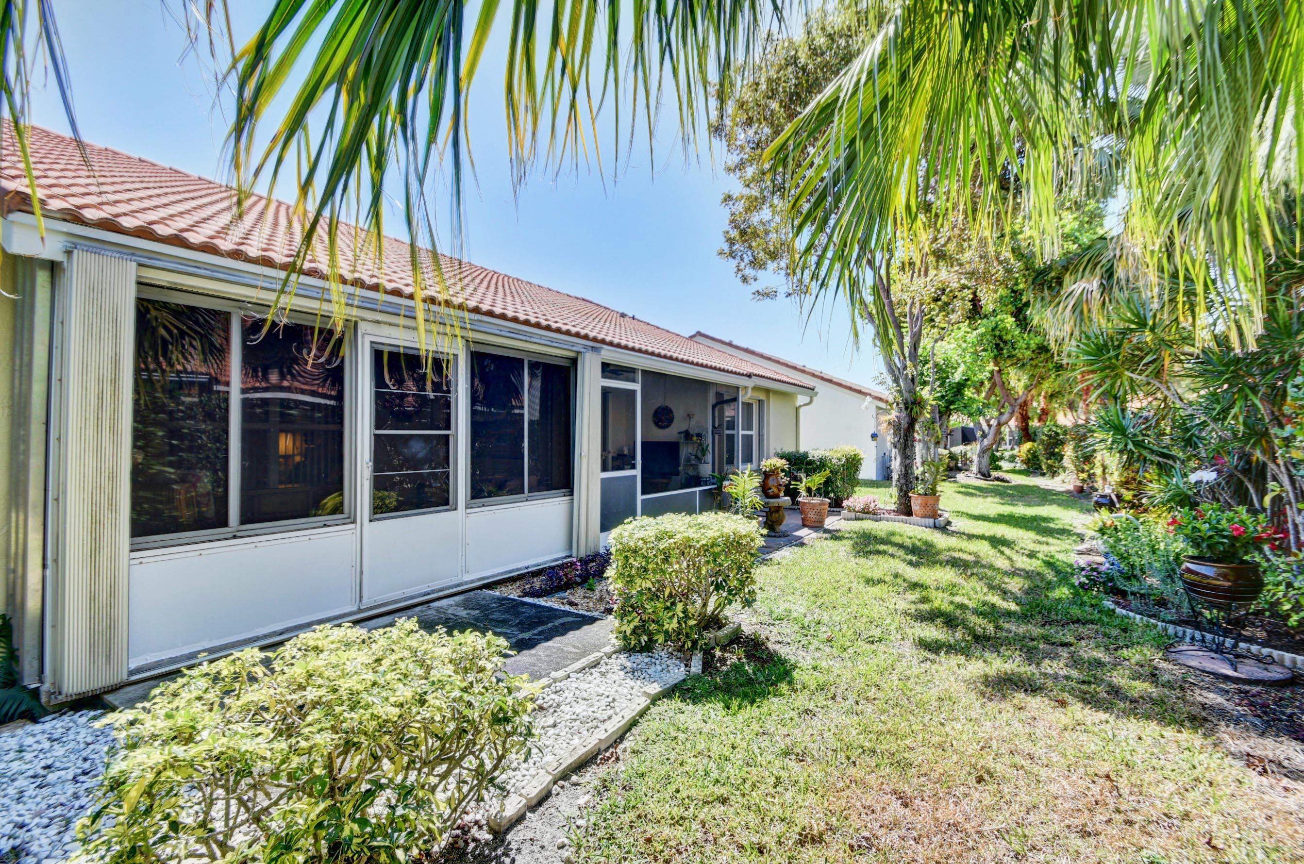 6121 Heliconia Road Delray Beach, FL 33484 - Photo 27 of 49 front view of a house with a yard