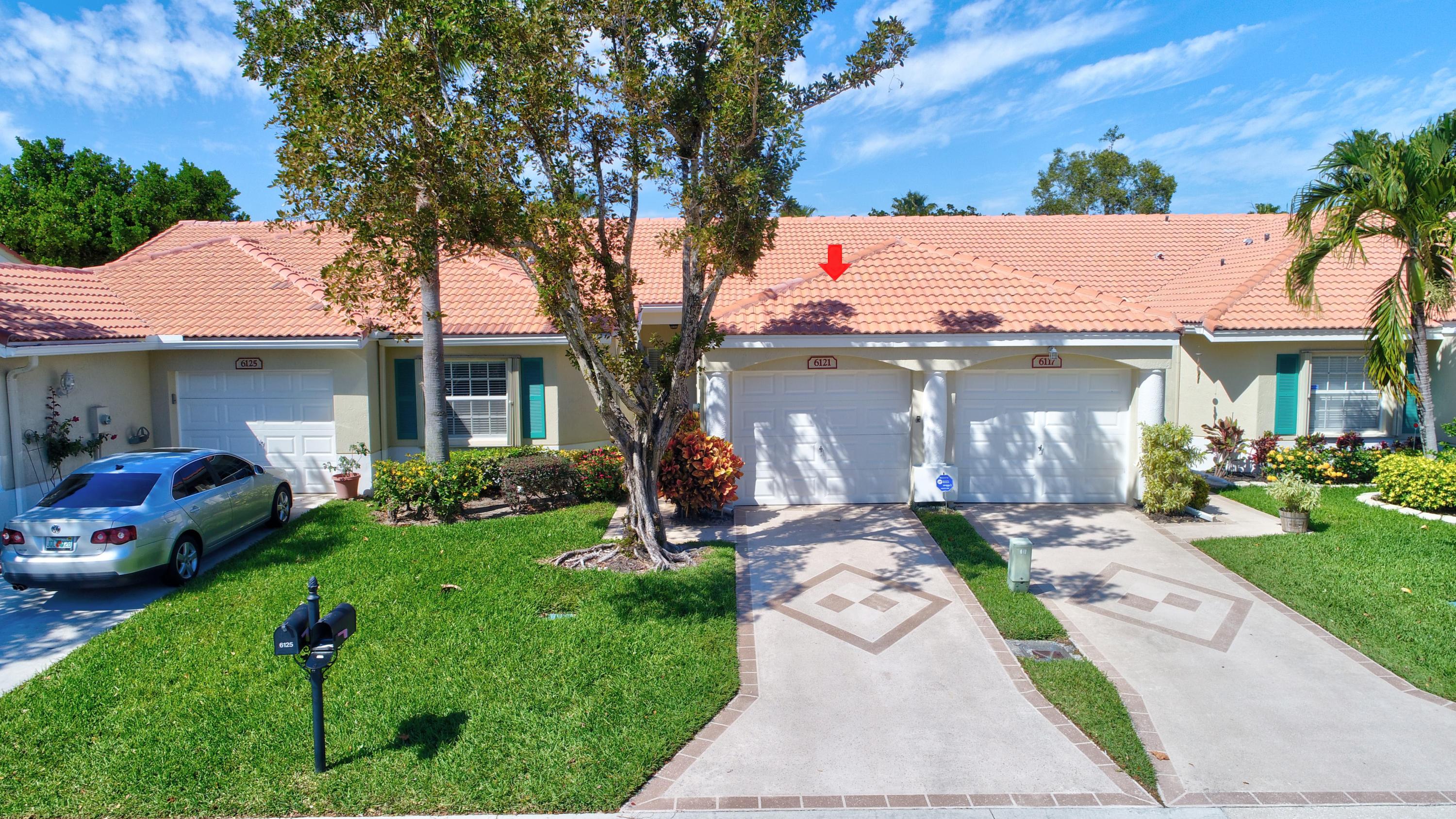 6121 Heliconia Road Delray Beach, FL 33484 - Photo 28 of 49 a front view of a house with garden