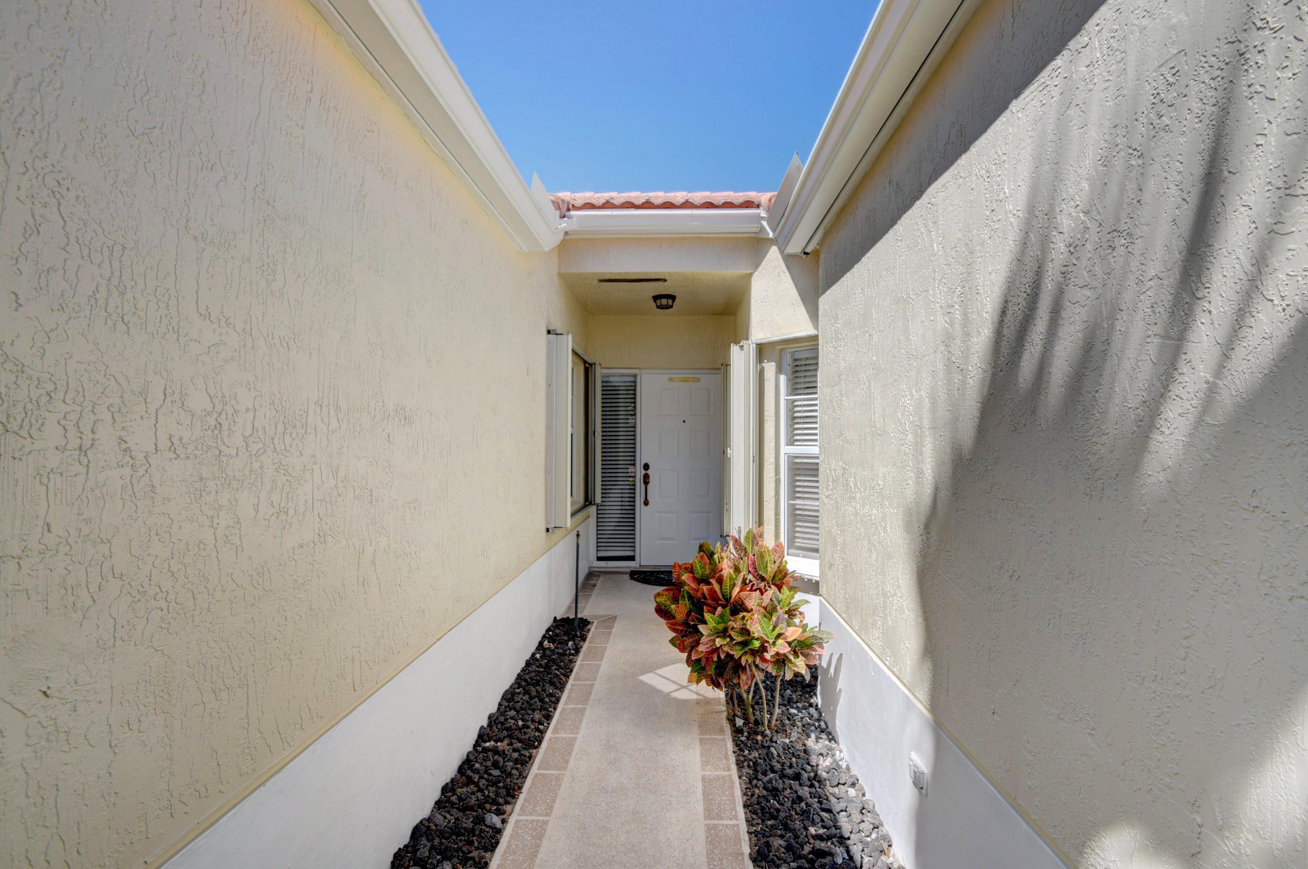 6121 Heliconia Road Delray Beach, FL 33484 - Photo 4 of 49 a potted plant sitting in front of a mirror