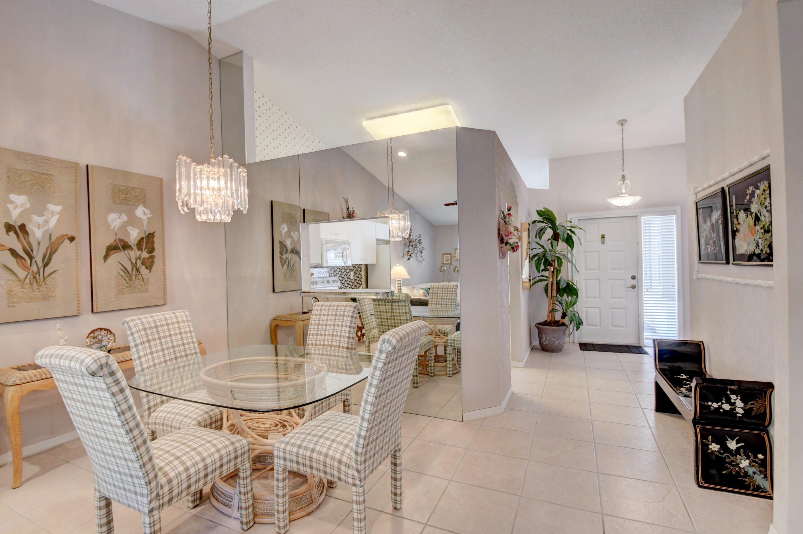 6121 Heliconia Road Delray Beach, FL 33484 - Photo 5 of 49 a dining room with furniture and chandelier