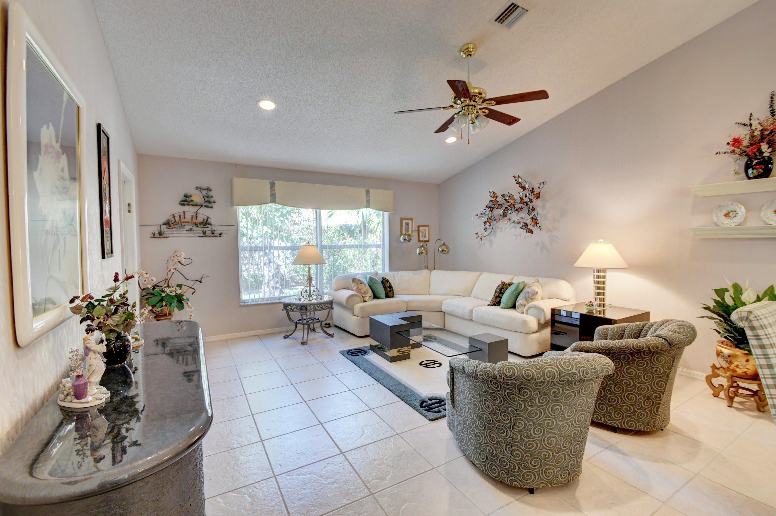 6121 Heliconia Road Delray Beach, FL 33484 - Photo 9 of 49 a living room with furniture and a large window