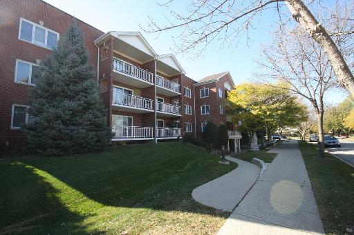 8650 North Shermer Road, Unit 307 Niles, IL 60714 - Photo 1 of 1 a view of a building with garden